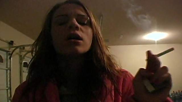Teenager in bathrobe smokes sensually