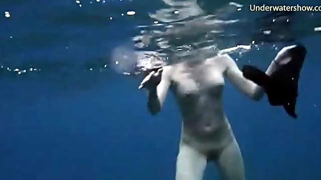 Beautiful girls swim naked in the deep ocean