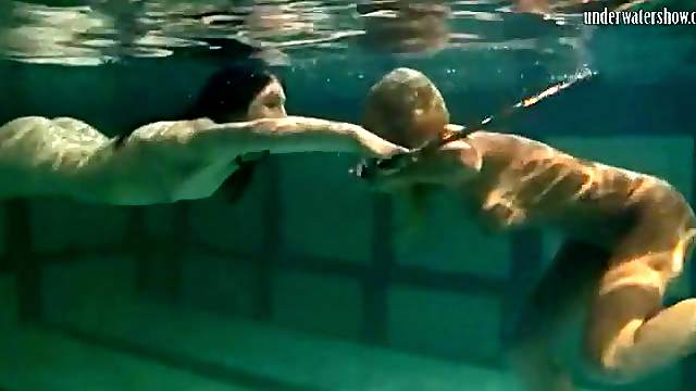 Underwater girls play with a hula hoop