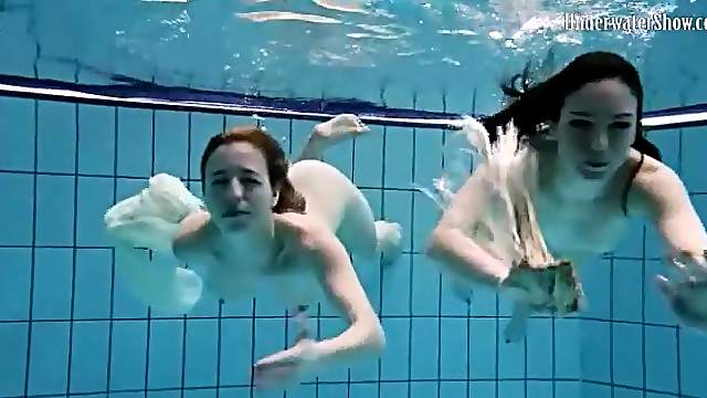 Nearly naked girls go swimming in the pool
