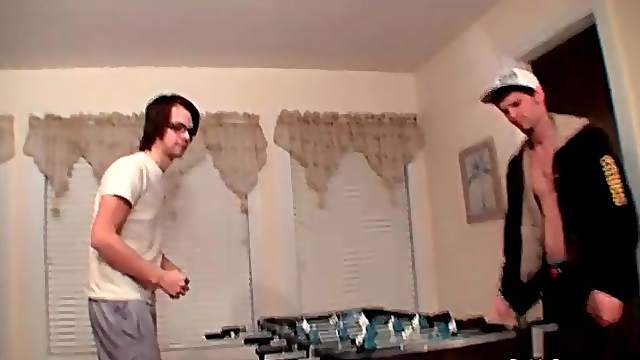Guys strip as they play foosball