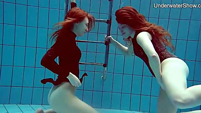 Underwater with two beauties in one piece swimsuits