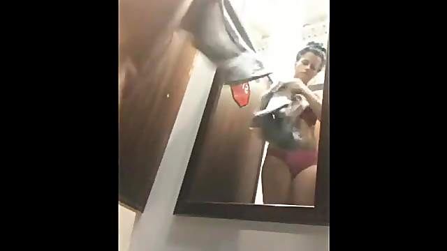 Girl in dressing room tries on clothes