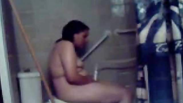 Chubby chick uses shower head to masturbate